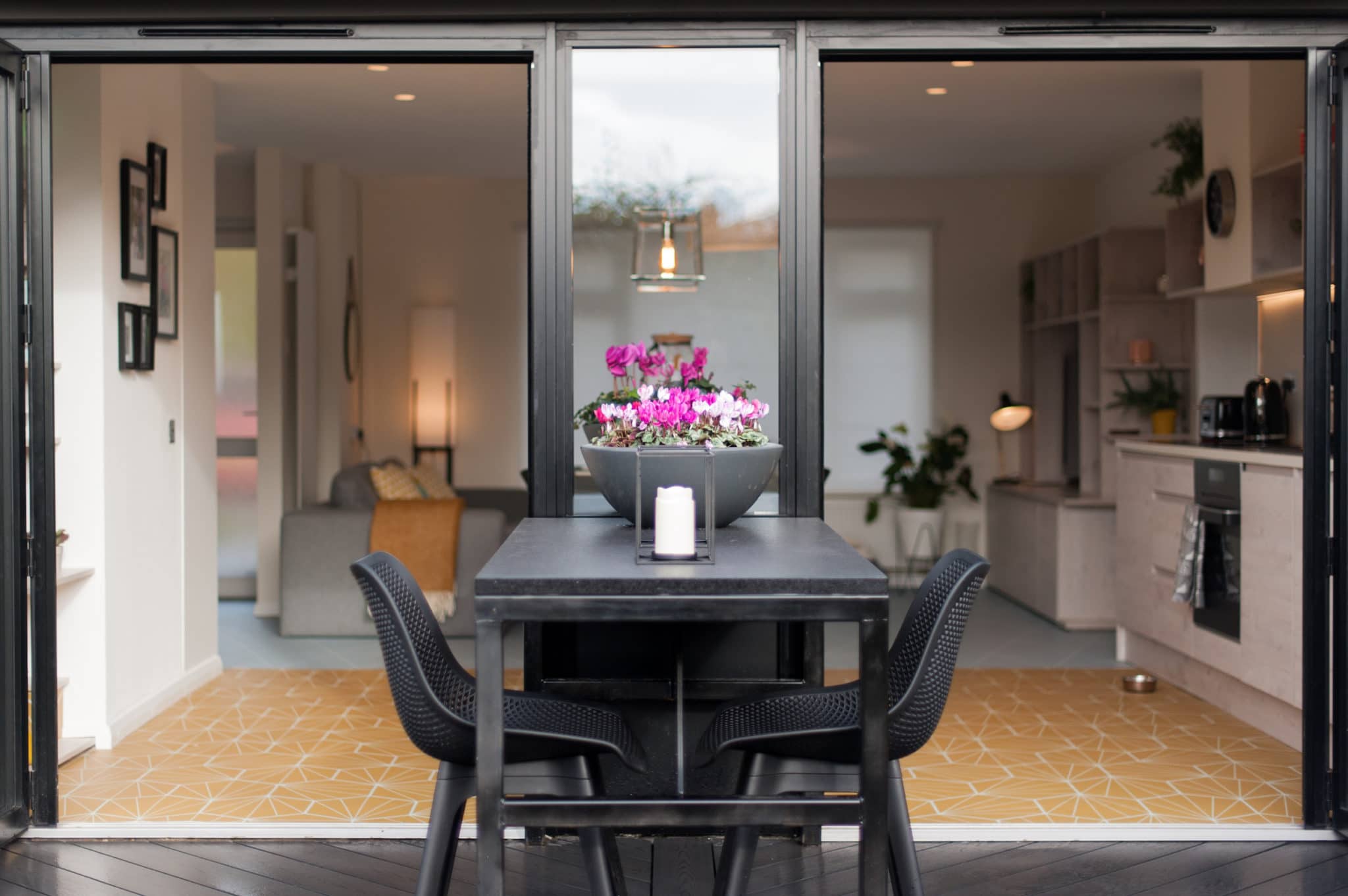 Black granite kitchen worktop. Half inside, half outside. Split by window.